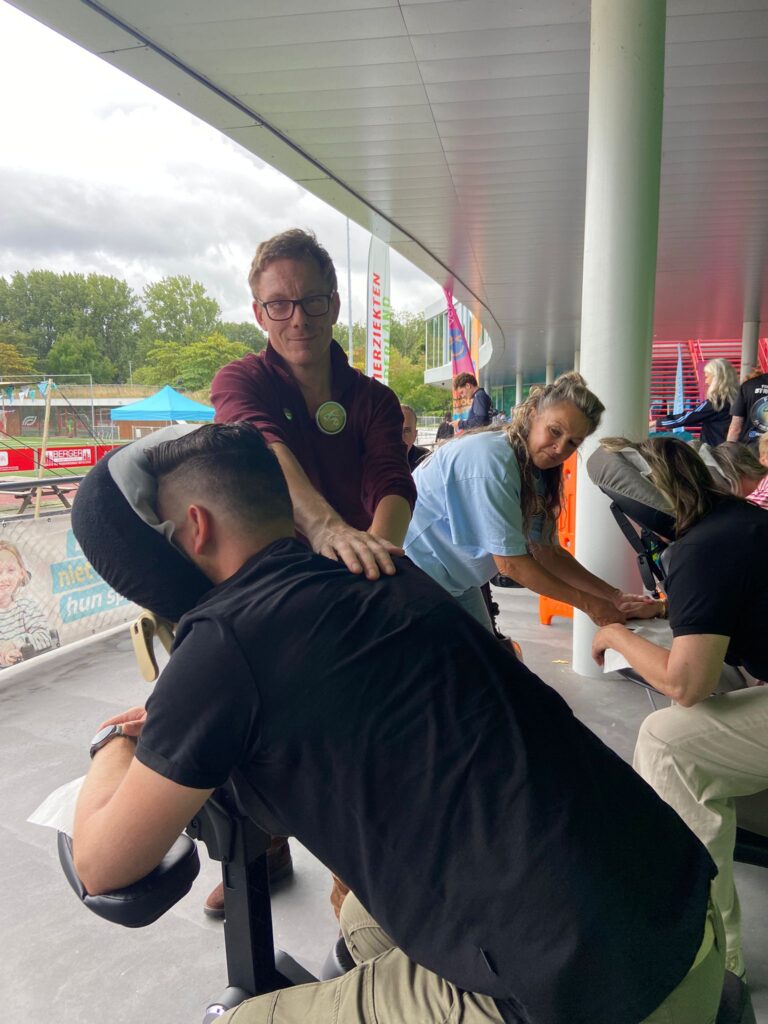 Masseur op stoel aan het masseren